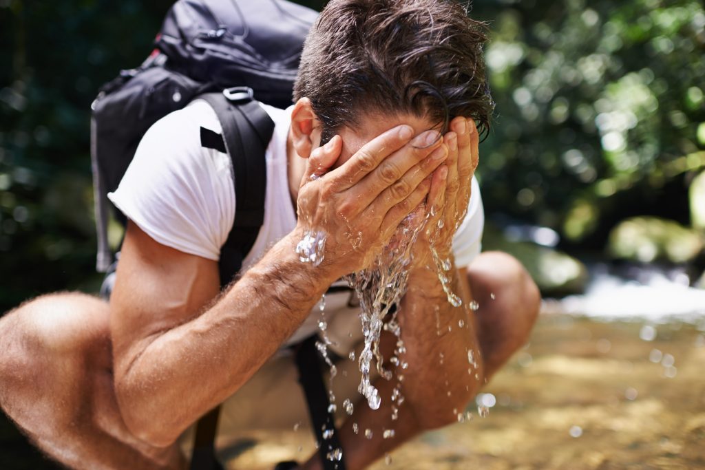man-washes-face-with-water-outdoors-2026-03-25-03-22-24-utc-1024x683
